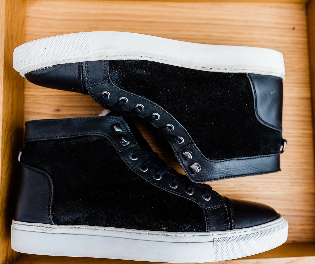 Black leather and cream shearling high top tennis shoe