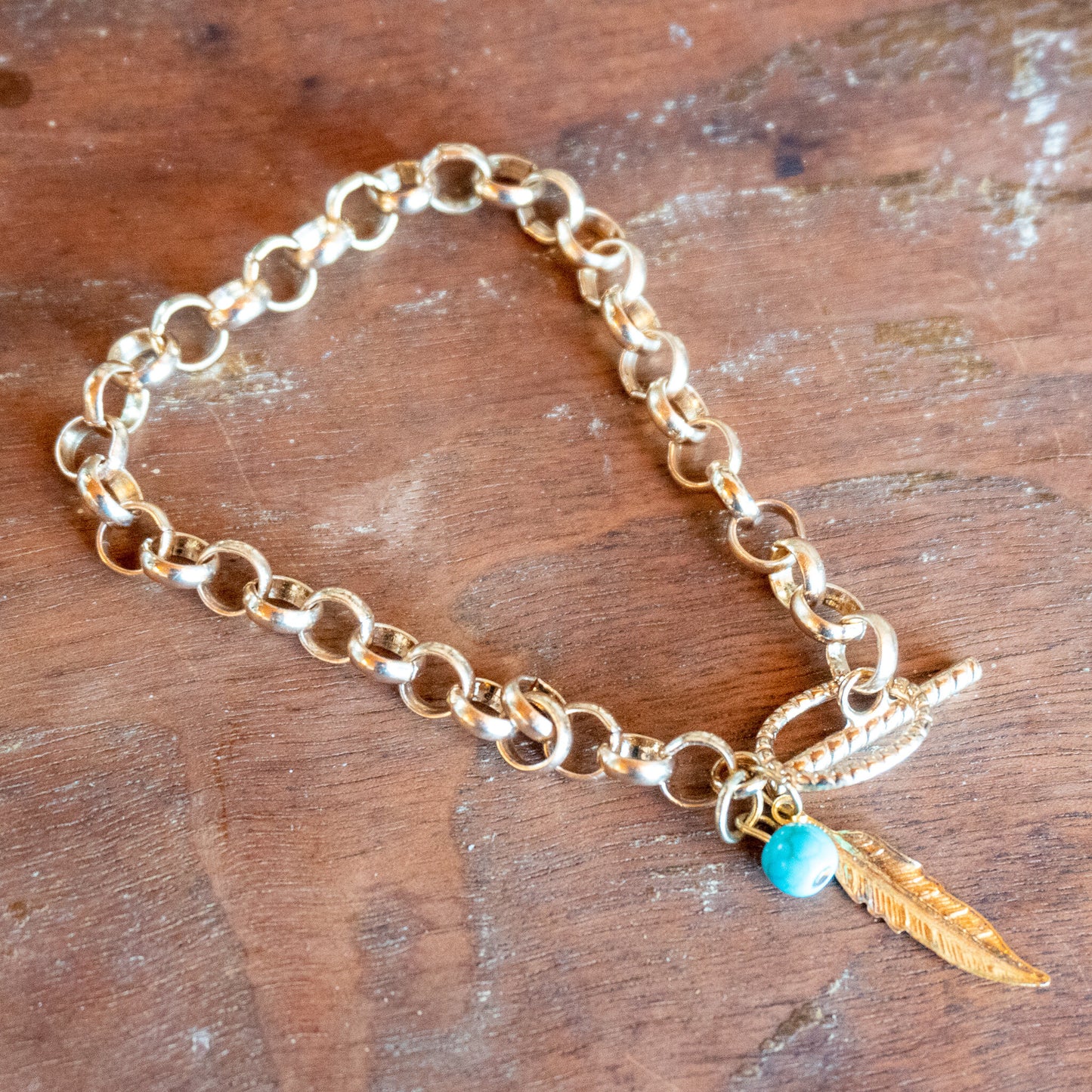 Gold Chained Toggle Bracelet with Feather Pendant